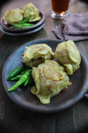 Crispy pork dumplings with green chilli on wooden plateの写真素材