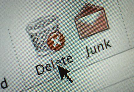 Close-up of an interface computer delete and junk mail buttons and an arrow cursorの写真素材