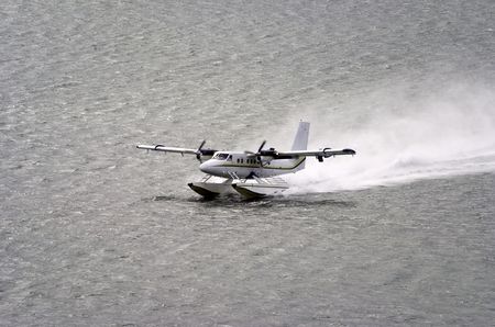 twin propeller engine hydroplan taking off from water surfaceの写真素材