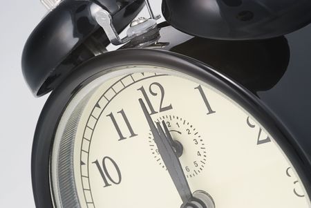 close up of an alarm clock set to  twelve o`clock 
