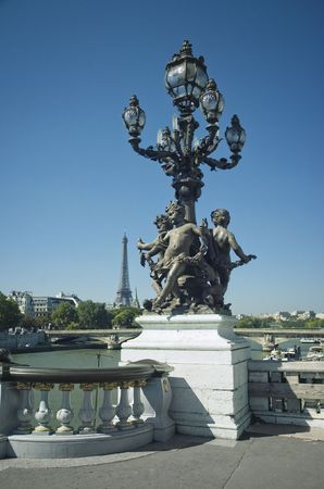 Pont Alexandre III Bridge with sculptures and lantern detail, against eiffel tower in Parisの写真素材