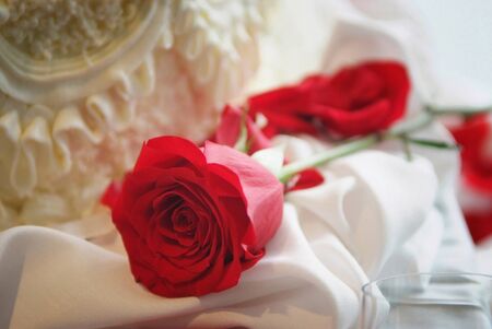 Close up of a roses and a glass on a bridal tableの写真素材