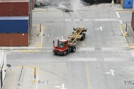 The cargo containers truck in storage area of freight port terminalの写真素材