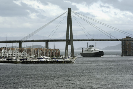 Car passenger ferry under harbour suspension bridge entering Stavanger Harbour, Stavanger, Rogaland,...