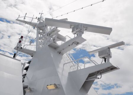 Satellite communication antenna on the top of large passenger ship. Close details of radar navigation system and communication tower.の写真素材