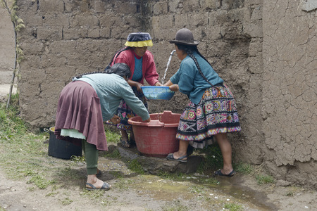 Indigenous women washing chopped raw potatoes in preparation for a traditional wedding ceremony. October 22, 2012 - Paru Paru, Peruのeditorial素材