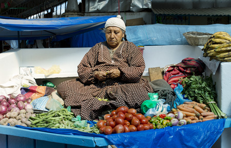 Indigenous Bolivian woman selling vegetables at the market in La Paz, Boliviaのeditorial素材