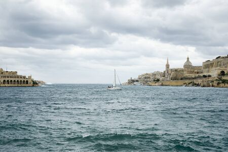 Sail boat navigating at Marsamxett Harbor, Maltaの写真素材