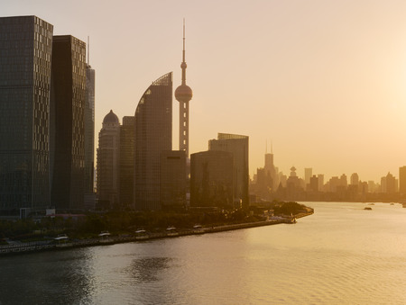 Shanghai skyline and Huangpu river in a beautiful dusk scene with sunset glowの写真素材