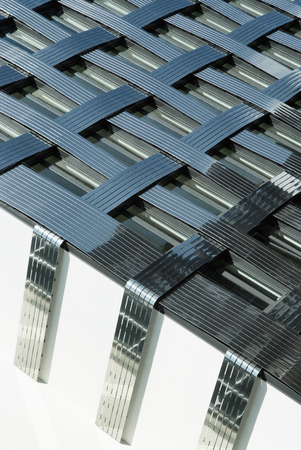 Fragment of a modern building. Abstarct crossing lines on facade.の写真素材