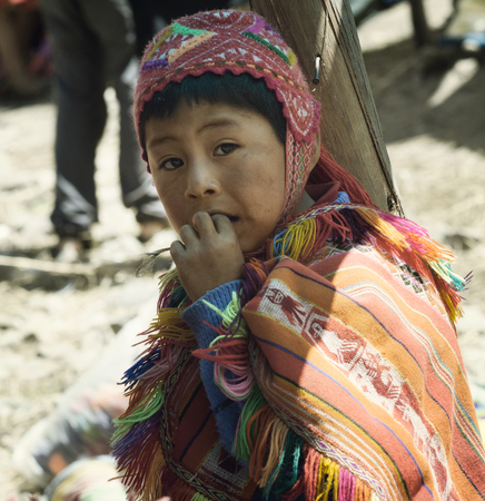 Peruvian boy dressed in colourful traditional handmade outfit. October 21, 2012 - Patachancha, Cuzco, Peruのeditorial素材