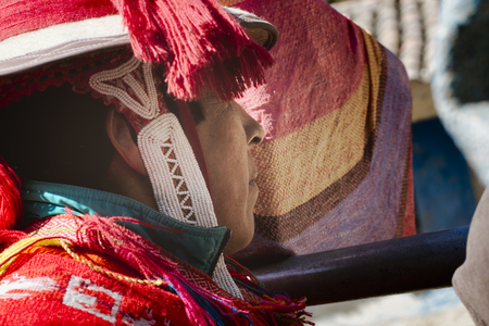Close up profile of a peruvian man dressed in colourful traditional handmade outfit. October 21, 2012 - Patachancha, Cuzco, Peruのeditorial素材