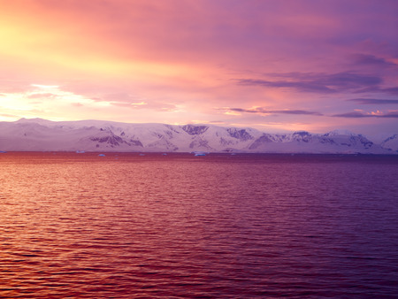 Sunrise Over Brabant Island, Gerlache Strait, Antarctica. Brabant Island Is The Second Largest Island In The Palmer Archipelago. Large Ice-Cliffs Protect Its Coastline From The Seaの写真素材