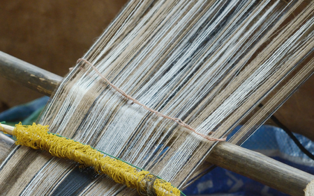 Vintage Manual Weaving Loom With Unfinished Textile Workの写真素材