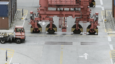 Cargo Containers, Truck And A Crane In Storage Area Of A Freight Port Terminalの写真素材
