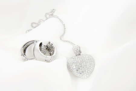 White Gold Earrings And Heart Shaped Pendant With Diamondsの写真素材