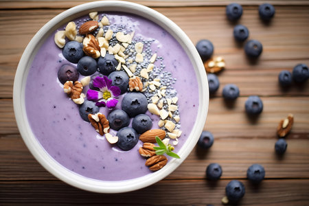 A nutritious smoothie bowl topped with blueberries, nuts, and seedsの素材