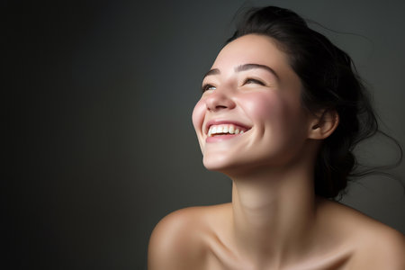Portrait of a joyful young woman laughing heartilyの素材
