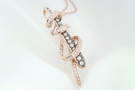 Exquisite rose gold necklace featuring a pendant with sparkling diamondsの写真素材