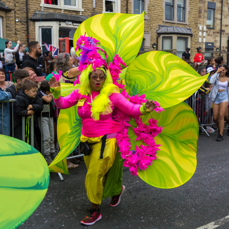 Leeds, United Kingdom - August 29, 2022: Woman in colorful flower costume in the Leeds West Indian Carnival Parade on Aug 29, 2022 in Leeds, United Kingdomのeditorial素材
