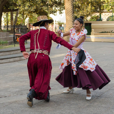 Salta, Argentina - August 7, 2021: Traditional Argentinian couple dancing in Plaza 9 de Julio on August 7, 2021 in Salta, Argentina.のeditorial素材