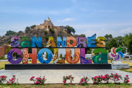 CHOLULA, PUEBLA, MEXICO - APRIL 12, 2022: Colorful Sign for San Andres de Cholula in front of the Giant Pyramid of Cholula and Santuario de la Virgen de los Remedios on April 12 in Cholula, Mexicoのeditorial素材