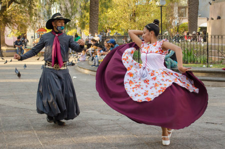 Salta, Argentina - August 7, 2021: Traditional Argentinian couple dancing in Plaza 9 de Julio on August 7, 2021 in Salta, Argentina.のeditorial素材