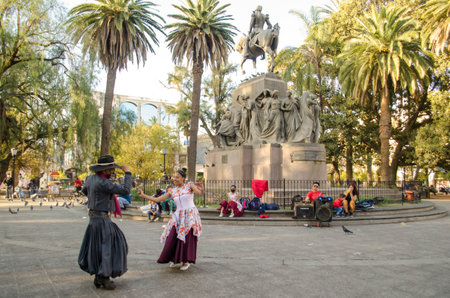 Salta, Argentina - August 7, 2021: Traditional Argentinian couple dancing in Plaza 9 de Julio on August 7, 2021 in Salta, Argentina.のeditorial素材