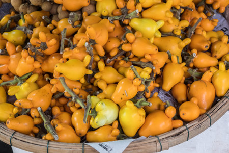 Fresh yellow nipple fruit or titty fruit or cows udder in the bamboo basket.の写真素材