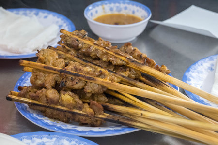 BBQ grilled pork skewers with peanut dipping sauce and rice paper in Hoi An, Vietnamの写真素材
