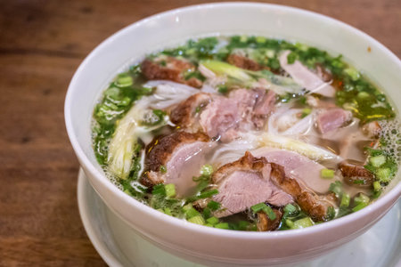 Vietnamese pho with duck with crispy skin, green onions and herbs in Hoi An, Vietnam