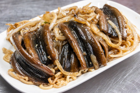 Delicious Taiwanese cuisine featuring grilled eel served on top of a plate of noodlesの写真素材