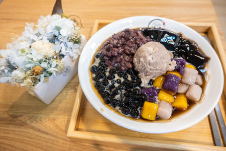 Colorful Taiwanese Dessert with Boba, Red Adzuki Beans, Grass Jelly, Taro Balls, and Mashed Taro in...
