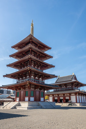 Stunning Shitenno-ji Temple in Osaka, Japan. Features a five story pagoda (Shitenno-ji Gojunoto) and Golden Hall (Shitenno-ji Kondo) against a clear blue sky.の写真素材