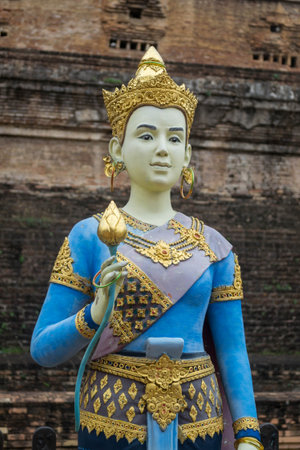 Female statue holding Lotus Flower at Wat Chedi Luang Varavihara, Chiang Mai, Thailandの写真素材