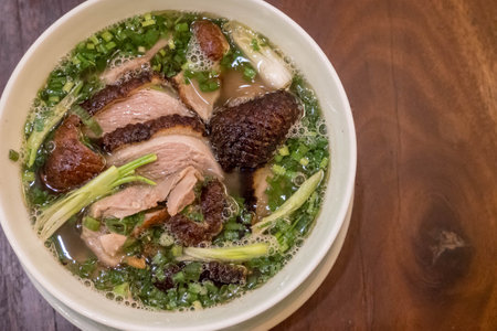 Vietnamese pho with duck with crispy skin, green onions and herbs in Hoi An, Vietnam