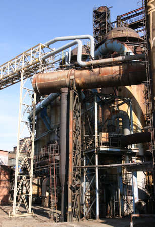 Old rusty factory construction against blue sky