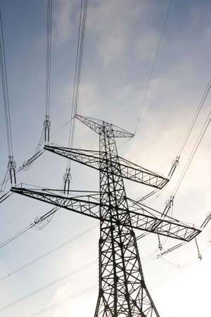 Electricity pole and wires against blue skyの写真素材