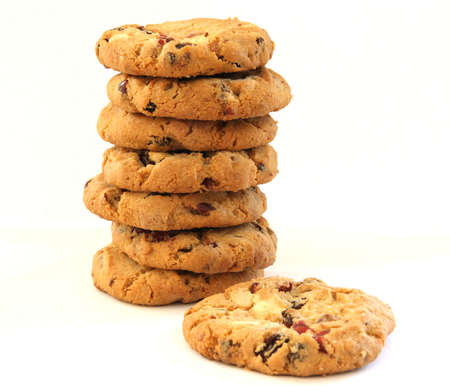 Stack of several chocolate chip hazelnut cookies with cranberries and one laying sepratellyの写真素材