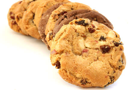Stack of several chocolate and hazelnut cookies with chocolate chips and cranberries