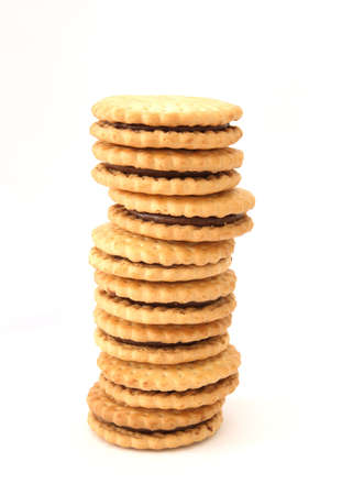 Stack of golden shortbread butter  biscuits filled with chocolate cacao fillingの写真素材