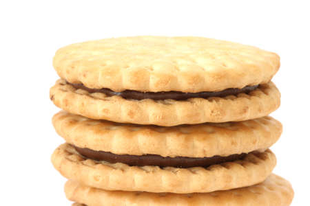 Stack of golden shortbread butter  biscuits filled with chocolate cacao fillingの写真素材