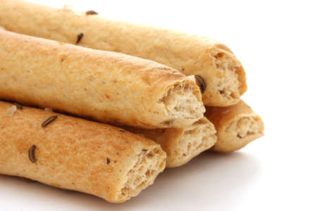 Salted bread sticks on white background, one partially bittenの写真素材