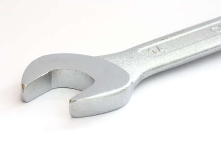 Single metal wrench part on white background