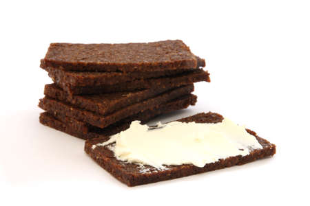 Stack of black dark bread loafs called pumpernickel - specific german healthy whole corn read with fresh white cheeseの写真素材