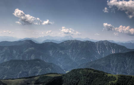 View of alps mountains distant range in moody foggy weatherの写真素材