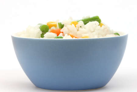 Close up view of cooked rice in blue bowl - with mixed of colorful vegetableの写真素材