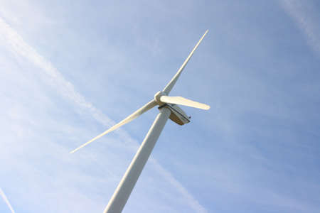 View of single windmill generating electricity against blue sky View of single windmill generating electricity against blue sky