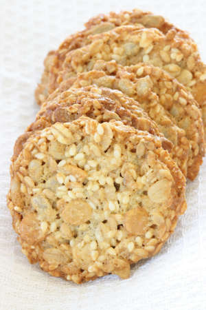 Stack of whole grain biscuits with white cloth in backgroundの写真素材