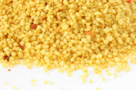Close up view of couscous scattered on white backgroundの写真素材